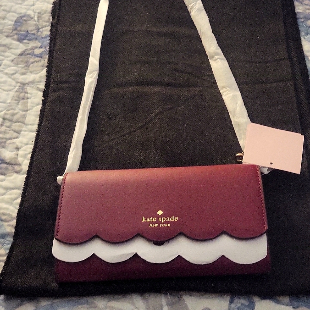 NWT Kate Spade wallet on a string Burgundy in color.
